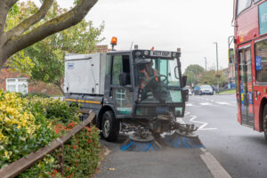 A mechanical sweeper cleaning the pavements.