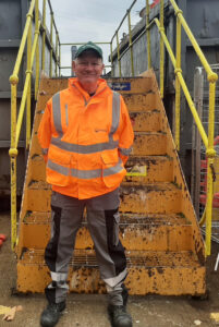 A member of the HRRC site team standing in front of gantry steps.