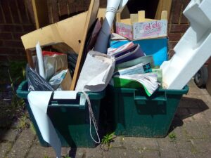 Photograph of recycling boxes containing items that cannot be recycled.