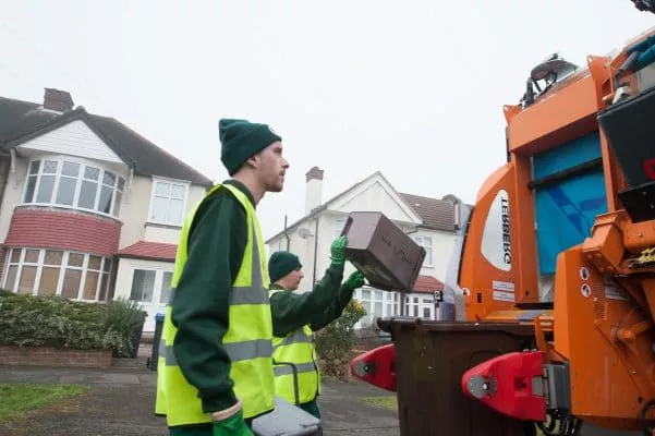 Image of a waste collection crew completing their rounds.